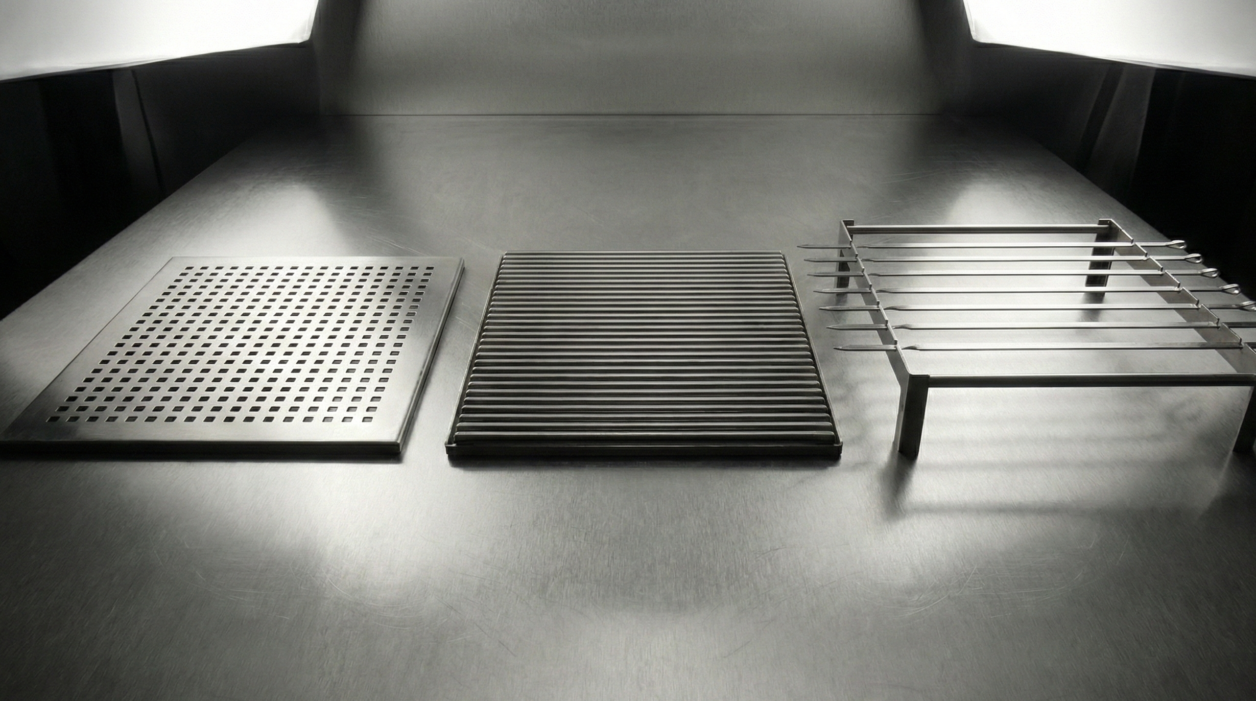 Three metal grates on a dark surface with a spotlight effect